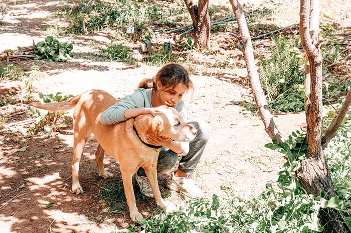 Enfant du Centre Fiers et Forts avec un chien dans le jardin